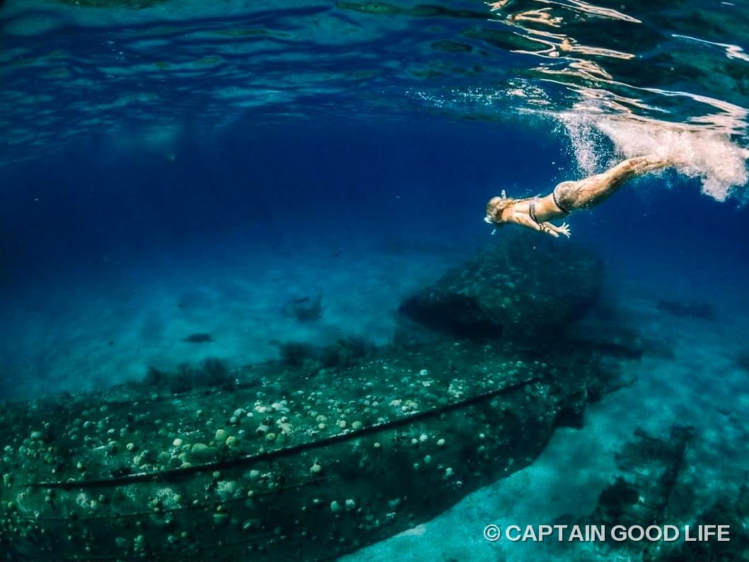 Snorkeler gliding over the shipwreck