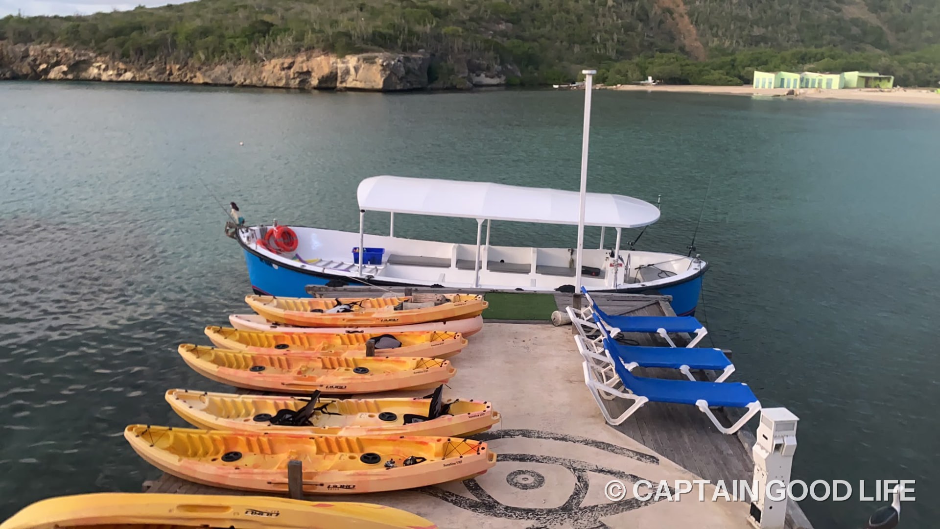 Yellow kayaks and the boat at the waterfront of Playa Santa Cruz