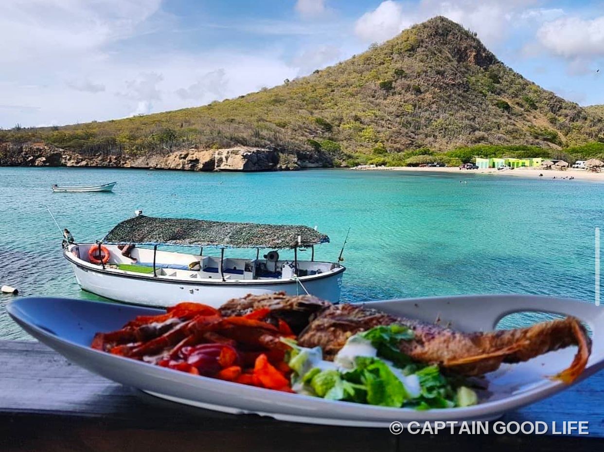 Fresh fish from the beach kitchen with the bay of Santa Cruz behind it